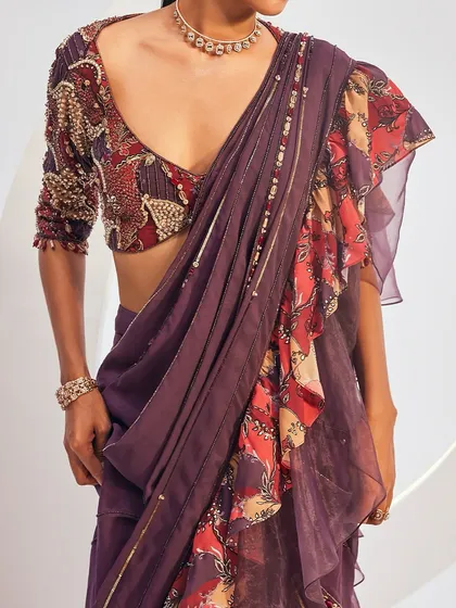 A detail shot of the DELILAH Saree Set, focusing on the embellished, printed blouse and the delicate highlights on the pre-draped saree.