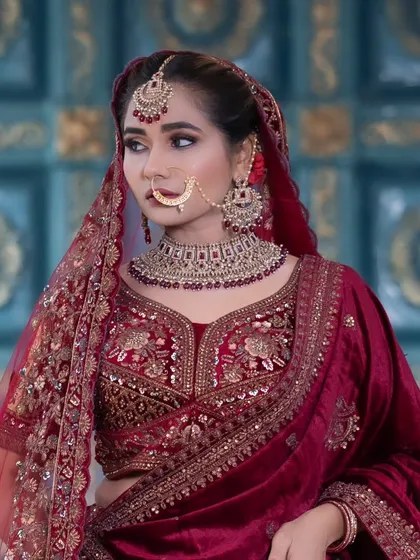 For my North Indian brides, I have a wide collection of Kundan and Jadau jewellery. This bridal set features a heavy choker with deep red stones, a matching maang tikka, and a traditional nath, perfect for a lehenga.
