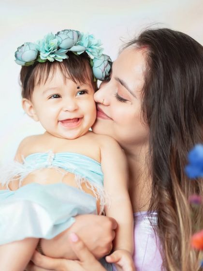 A joyful moment between a mother and her laughing baby. These candid shots are often the most treasured from our Mother's Day mini sessions.