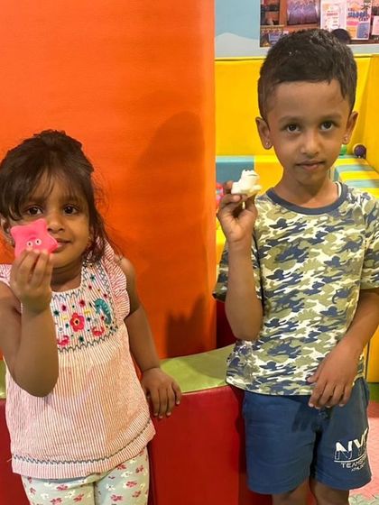 Two young friends showing off their creations. Moments like these, after a decade in service, remind us of the joy we aim to bring to every child.