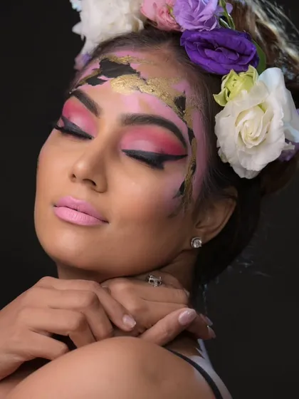 A beautiful floral and gold leaf editorial look. This combines soft beauty makeup with artistic elements, showing great versatility.