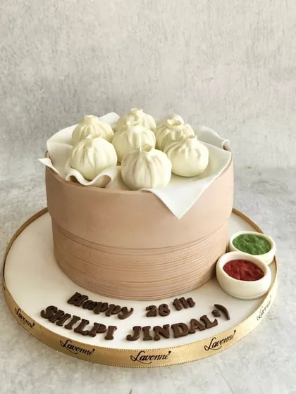 A cake for a momo lover! This entire dim sum steamer basket is a cake, and the momos on top are made of fondant. It was a delicious challenge to make it look so realistic.