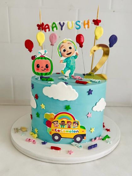 A sweet Cocomelon cake with JJ, the iconic watermelon, and a colorful school bus.