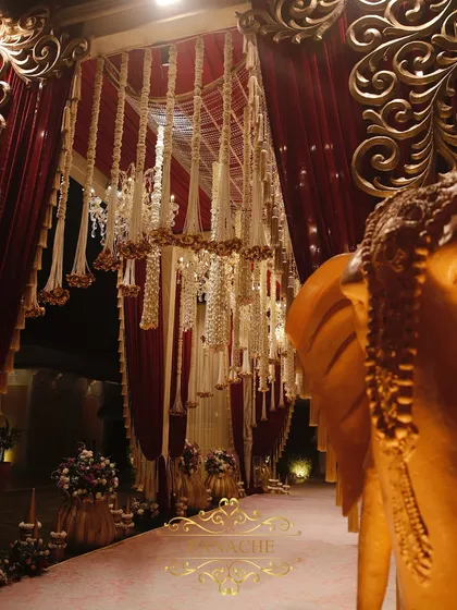 A detail of the grand entryway, where a majestic golden elephant statue stands guard. These elements are key to building an authentic, palace-like atmosphere for a destination wedding in places like Jaipur.