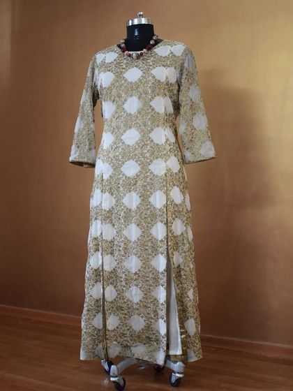 A full view of the gold and white printed kurta, showcasing its straight-cut silhouette and side slits for ease of movement.
