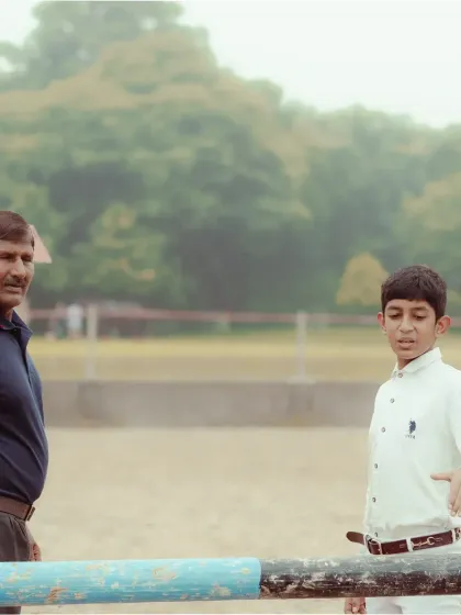 A coach gives last-minute advice to a young rider before a competition. Our trainers provide guidance every step of the way.