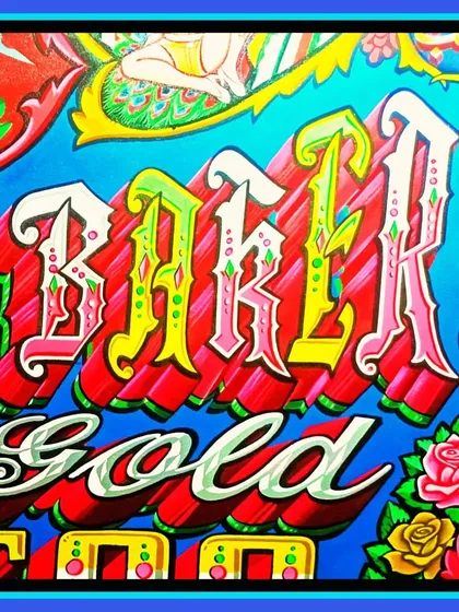 A close-up on the "Baker" lettering from the Noryan Baker sign, showing the intricate details and color blending.