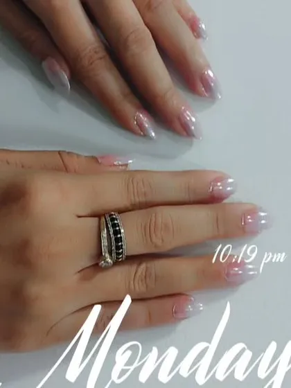 A still photo of the pearly chrome nails, showing how they look elegant and clean against a simple background.
