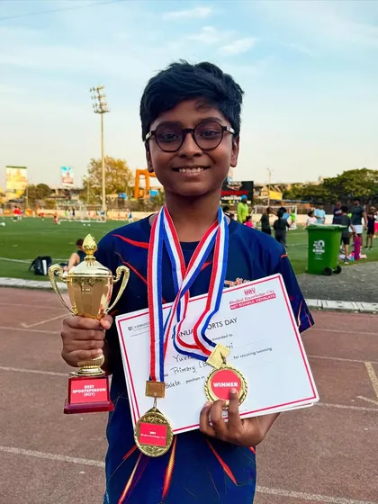 Yuvraj looking proud with his two gold medals and the Best Athlete trophy from his school athletic meet. An outstanding achievement built on consistent training.