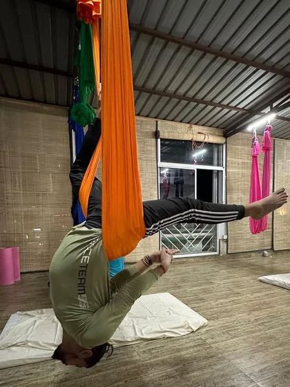 Come fly with me. This pose is a variation of a supported headstand, which helps in strengthening the arms and shoulders while decompressing the neck.