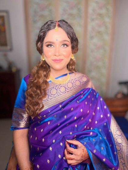 A beautiful portrait of this mom-to-be, looking elegant and serene in her purple silk saree.
