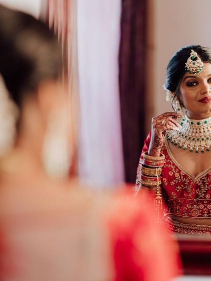 The mirror shot. A moment of reflection for the bride as she admires her final look. The makeup looks perfect from every angle.