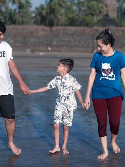 A candid moment of a family walking together on the beach. I love capturing these simple interactions that show the natural bond between parents and their child.