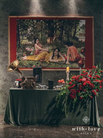 The welcome installation, featuring a painting of Shakuntala, a vintage gramophone, and a dramatic floral arrangement. This sets the stage for a night of timeless romance and storytelling.