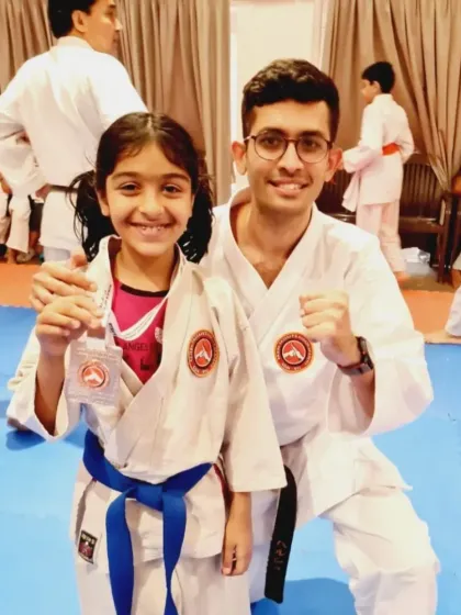 A young student and her instructor celebrate her medal win. We believe in nurturing talent and providing encouragement every step of the way.