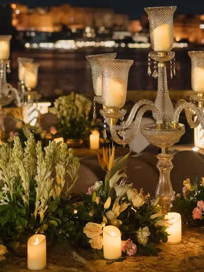 For this destination wedding in Udaipur, I designed an evening ceremony on the water's edge. The decor, featuring elegant candelabras and soft florals, was created to complement the romantic, historic city skyline.