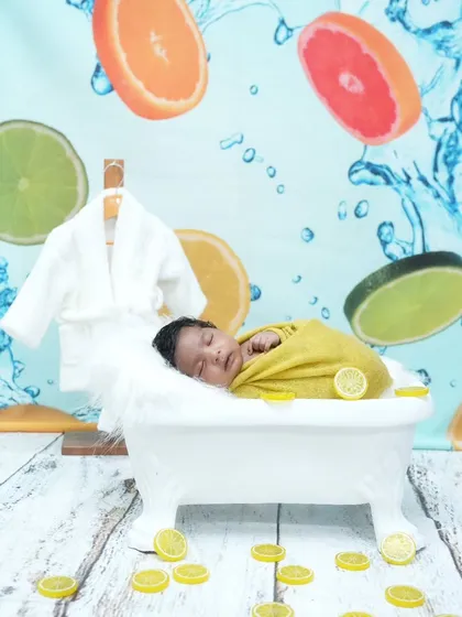 Another angle of our popular citrus bath theme, showing the full setup with the fruit-themed backdrop and a tiny bathrobe waiting.