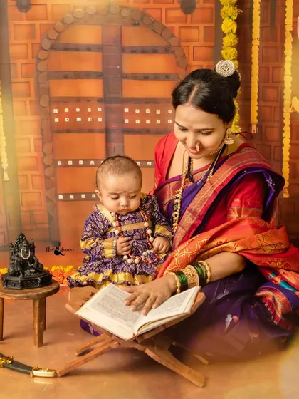 A mother teaches her child the stories of our ancestors. This touching moment was captured during our Shiv Jayanti mini-session, set against a backdrop resembling a historic fort.
