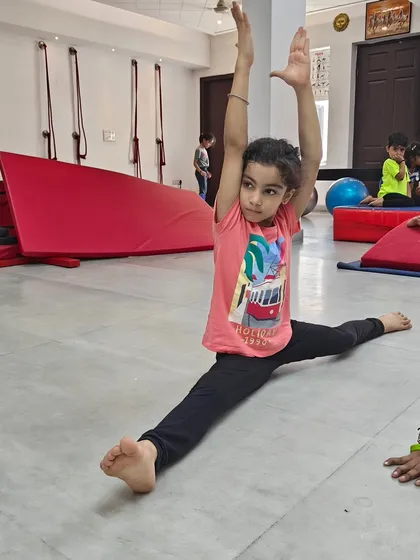 Look at this amazing progress. This young student is demonstrating a full front split, a result of consistent practice and flexibility training in my gymnastics class. I celebrate every milestone, big or small, because it builds a child's confidence for life.