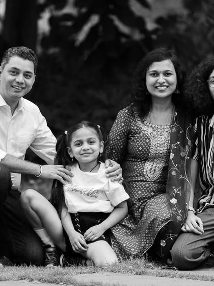 The black and white version of a family portrait. This edit gives the image a classic, documentary feel, focusing on the family's happy expressions.