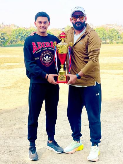 With one of my senior players, holding the trophy after another tournament victory.