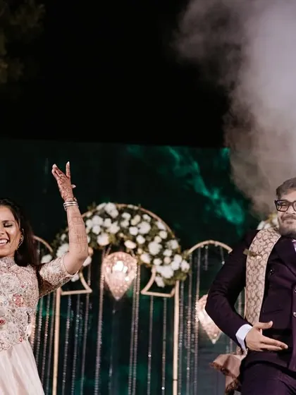 A couple from the family performs with a smoke gun, adding a fun and modern twist to their dance.