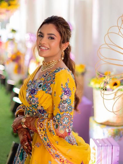 A textured, messy ponytail is a great option for a fun pre-wedding event like a mehendi or haldi. It's stylish, comfortable, and keeps the hair off the face.