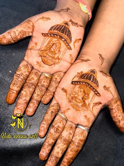The stained version of the king and queen in a jharokha design. The rich, dark color of the henna stain is the result of using high quality, natural henna paste.