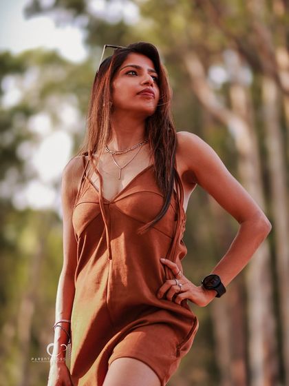Bathed in the warm glow of the golden hour. This outdoor portrait captures a sense of freedom and adventure, with the light beautifully highlighting her hair and profile.