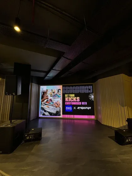 The full stage view before the event begins. Our setups are designed to look professional and exciting, building anticipation for the live art activation.