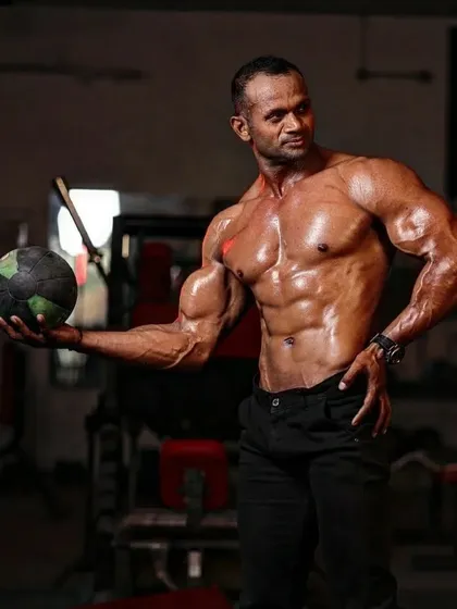 Holding a medicine ball. Functional strength bhi utni hi zaroori hai jitni muscle size.