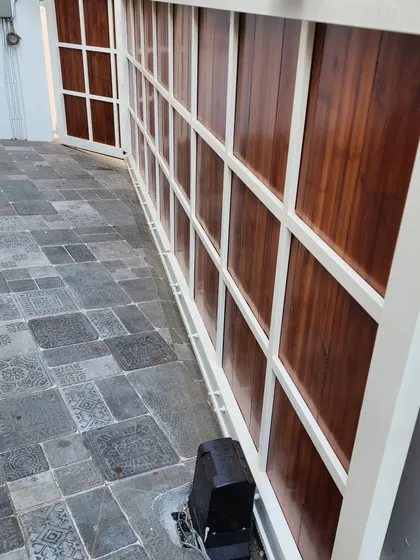 This view from inside the property shows the gate's motor and the clean floor line. Our trackless systems are not only functional but also enhance the aesthetic appeal of your entrance.