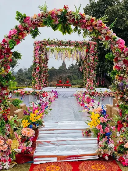 An outdoor mandap with a view. I designed this beautiful floral archway and mandap to frame the natural scenery, creating a serene and picturesque setting for the wedding ceremony.