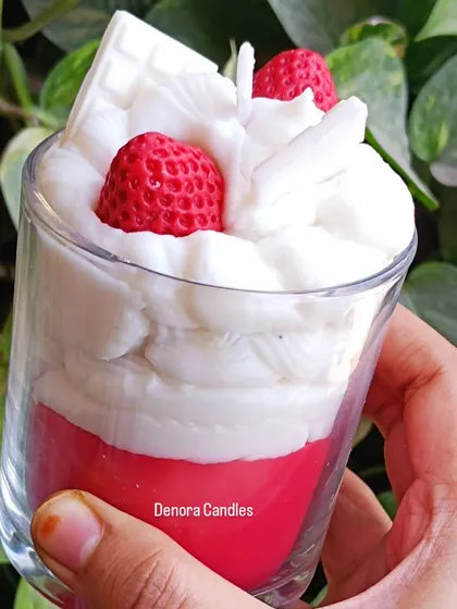 A side view of the strawberry and cream dessert candle.