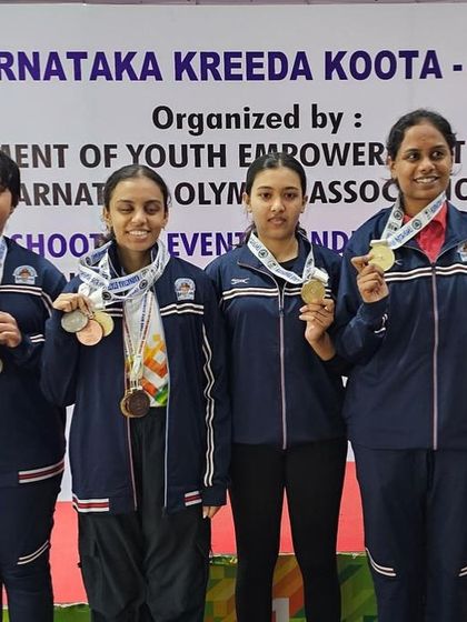Our women's team proudly displaying their medals after a successful run at the state level championships.