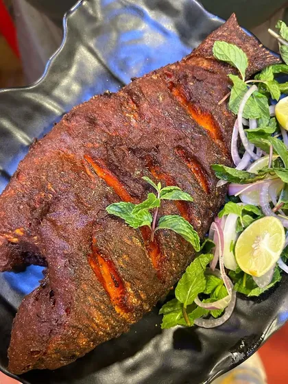 Another look at our perfectly plated Tandoori Fried Fish. The crispy skin and tender flesh, combined with the zesty salad, make this our undisputed best-seller.