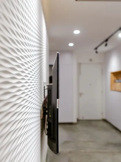 A close-up of the textured white wave board used on the TV wall in the T7 T8 project, adding subtle visual interest.