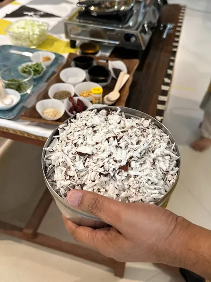 A bowl of freshly grated coconut, a key ingredient in many of our sattvic South Indian dishes. We use fresh, natural ingredients to create food that is both delicious and nourishing.