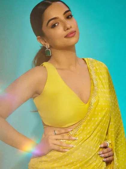 The final look! Ahsaas Channa looking radiant in a yellow sari, with her custom white and gold nails adding the perfect touch of elegance.