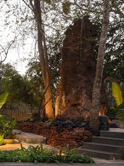 The landscape at Sanctuary Bar, where strategic uplighting highlights the texture of the ancient ruins and surrounding trees. This creates a dramatic and atmospheric setting for the evening.