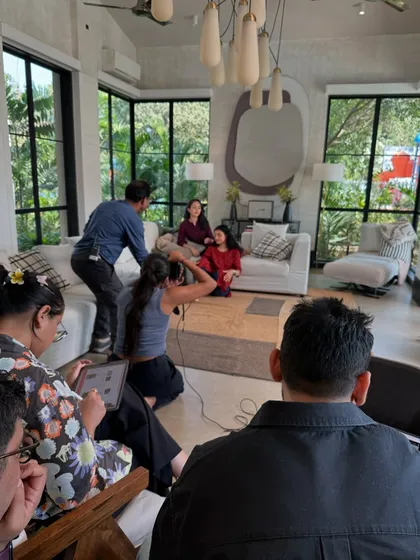A wider view of a shoot in progress. It shows the full team at work, from me behind the camera to assistants and clients observing the process.