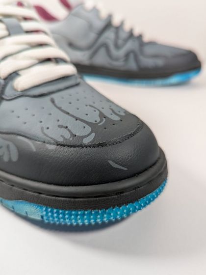 A close-up of the toe box, where the Venom symbiote appears to be dripping down the front of the shoe.