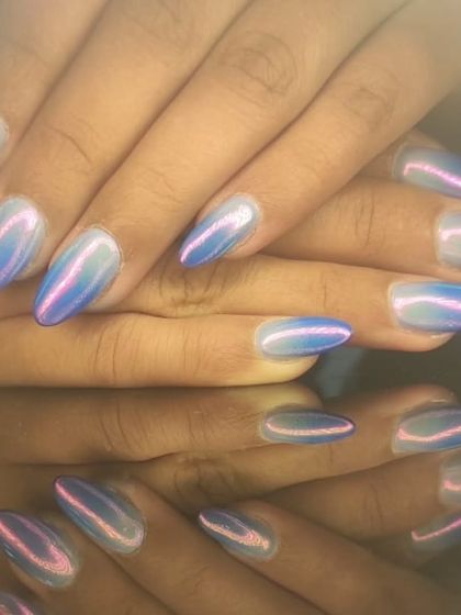 An iridescent chrome finish that shifts between blue and pink, creating a unicorn-like effect on almond nails.