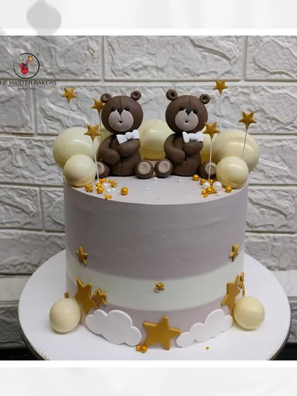 Double the cuteness with this twin teddy bear cake. Set against a backdrop of fondant stars and clouds, this design is perfect for a baby shower or a little one's birthday.