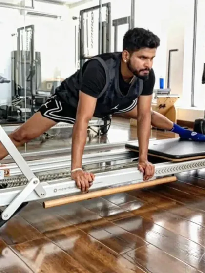 Shreyas Iyer performs an advanced stretch on the reformer, targeting his hamstrings and inner thighs. For athletes, flexibility is just as important as strength for power and injury prevention.