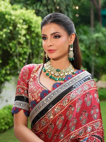 An outdoor shot where the natural light beautifully illuminates her radiant makeup. The look is fresh and elegant, perfect for a day-to-evening transition.