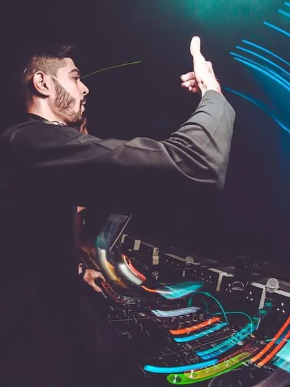 This long-exposure photo captures the movement and energy of a club night. My hand gesture signals to the crowd, getting them ready for the next big drop. This is what crowd control looks like.