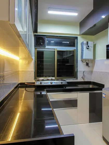 Another view of the kitchen with the black granite top, highlighting the under-cabinet lighting.