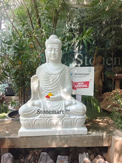 This 3-foot Buddha statue is carved from a single block of white marble. The Abhaya Mudra posture signifies protection and fearlessness, making it a perfect serene addition to a home or garden.