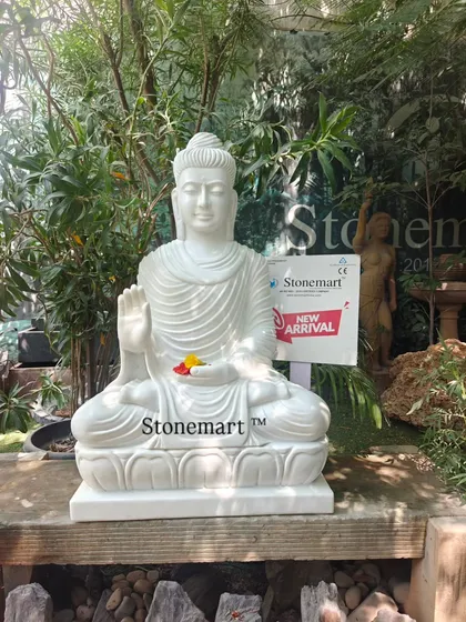 This 3-foot Buddha statue is carved from a single block of white marble. The Abhaya Mudra posture signifies protection and fearlessness, making it a perfect serene addition to a home or garden.
